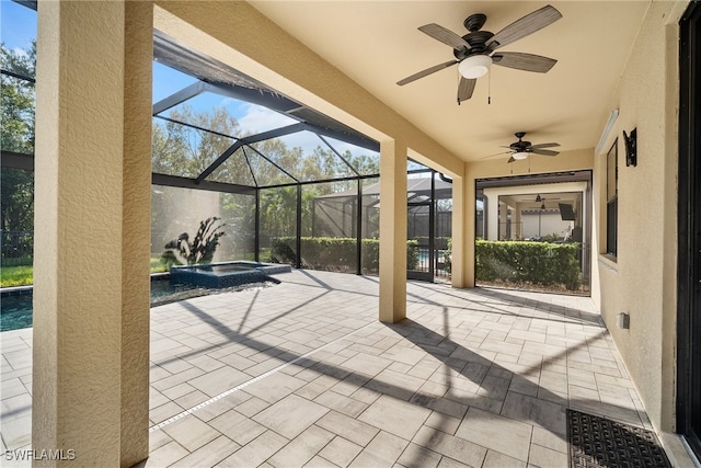 view of patio / terrace with a lanai, an in ground hot tub, and ceiling fan