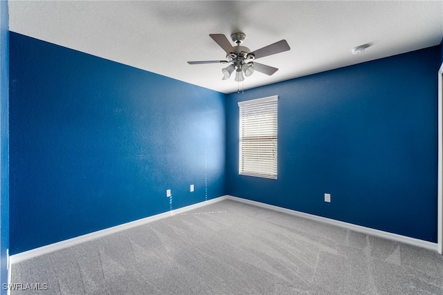 spare room with carpet floors and ceiling fan