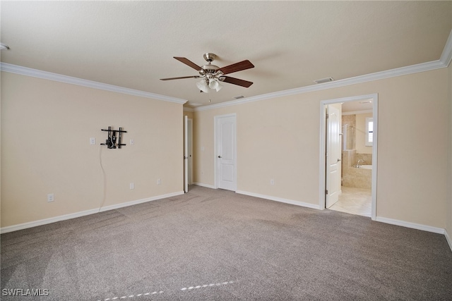 spare room featuring ornamental molding, carpet flooring, and ceiling fan