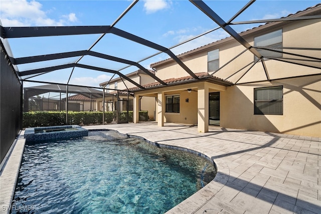 view of pool featuring an in ground hot tub, a patio area, and glass enclosure