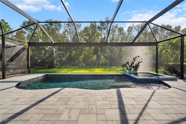 view of swimming pool featuring an in ground hot tub, a patio, and a lanai