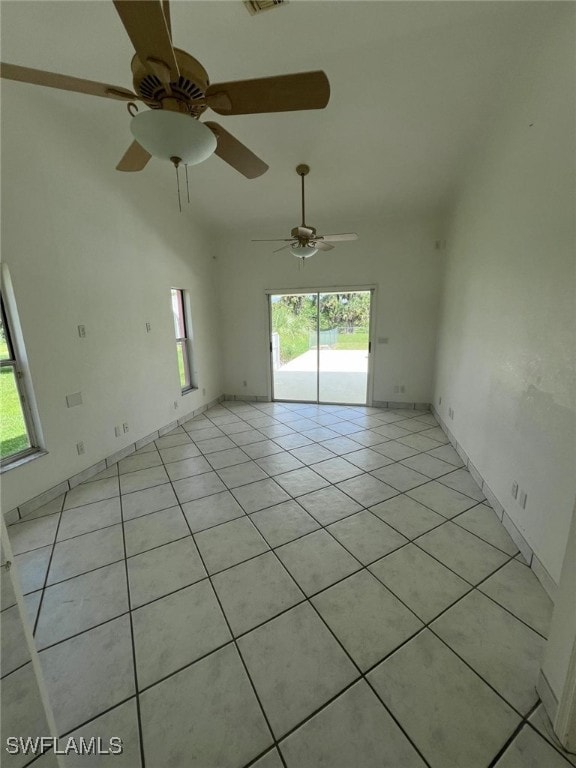 tiled spare room featuring ceiling fan