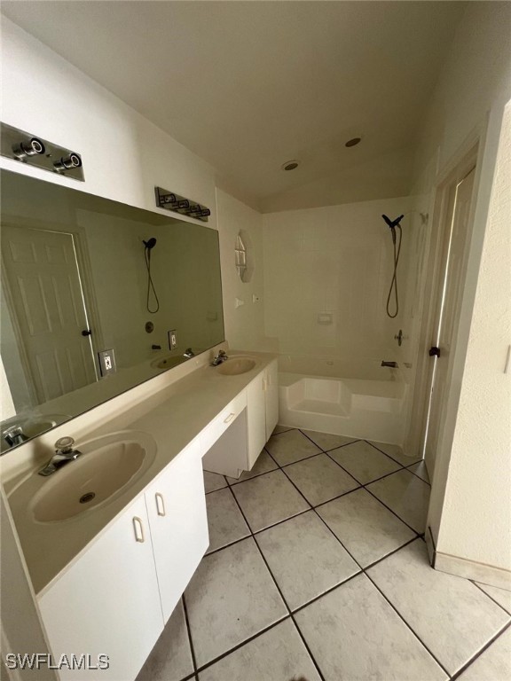 bathroom with tiled shower / bath, vanity, and tile patterned floors