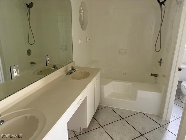 full bathroom featuring toilet, tiled shower / bath, vanity, and tile patterned floors