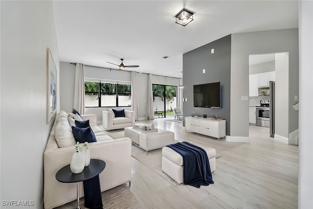 living room with ceiling fan and light hardwood / wood-style floors