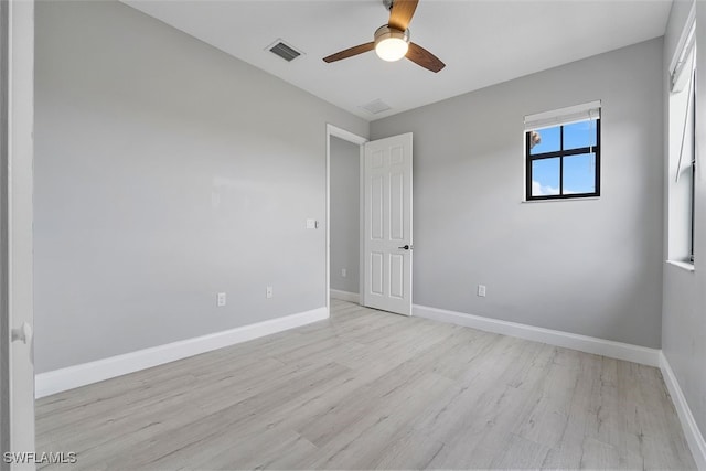 unfurnished room with light wood-type flooring and ceiling fan