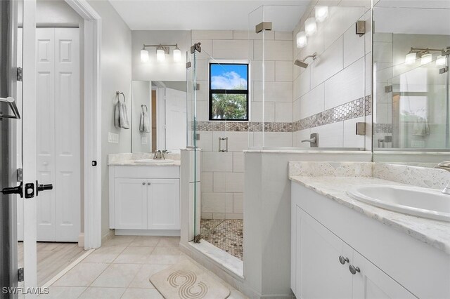 bathroom with vanity, an enclosed shower, and tile patterned flooring