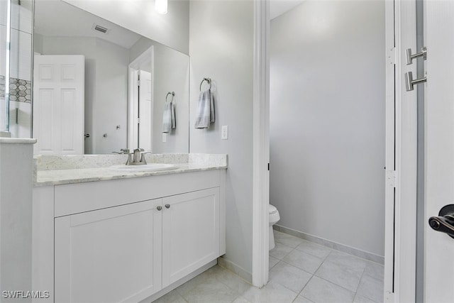 bathroom with vanity, toilet, and tile patterned flooring