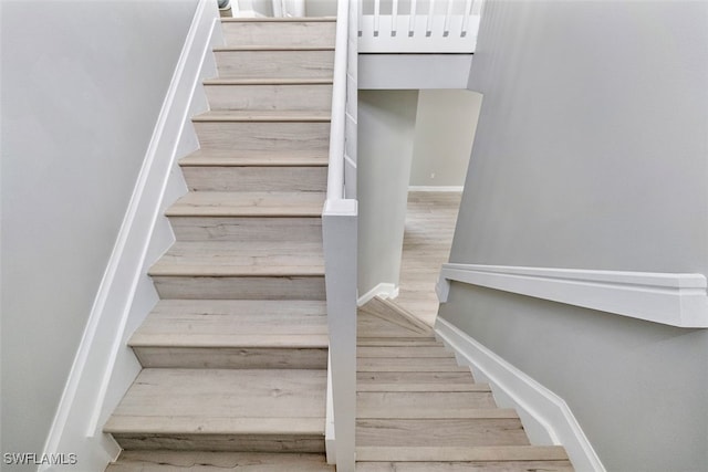 staircase with wood-type flooring