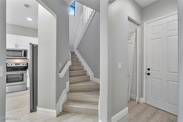 stairway featuring hardwood / wood-style flooring