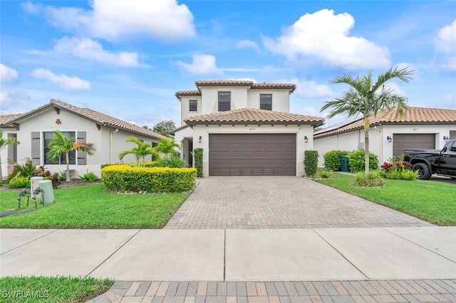 mediterranean / spanish home with a front yard and a garage