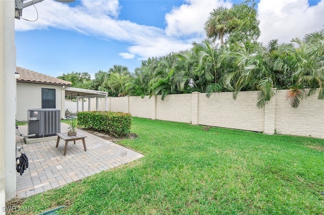 view of yard featuring a patio area and central AC unit