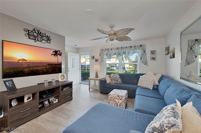 living room featuring light hardwood / wood-style floors and ceiling fan