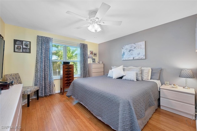 bedroom with light hardwood / wood-style floors and ceiling fan