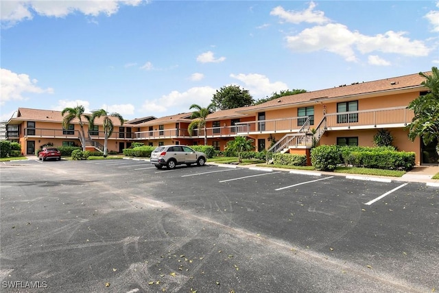 14 Manor Ter Unit 9-106, Marco Island, FL 34145 - uncovered parking lot featuring stairs and a residential view