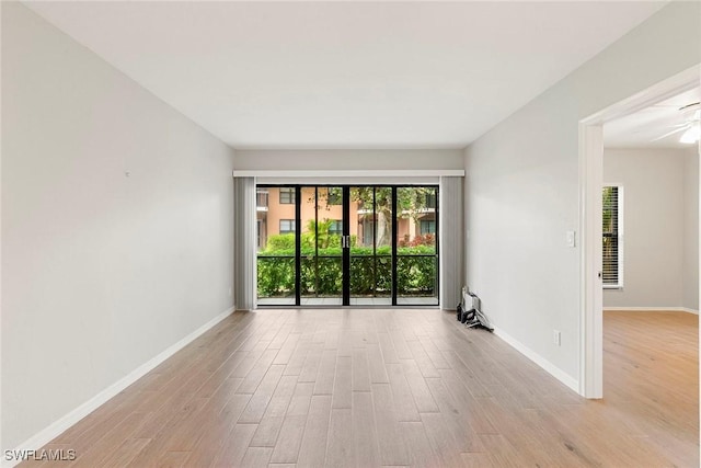 14 Manor Ter Unit 9-106, Marco Island, FL 34145 - empty room with wood finished floors, a ceiling fan, and a heating unit