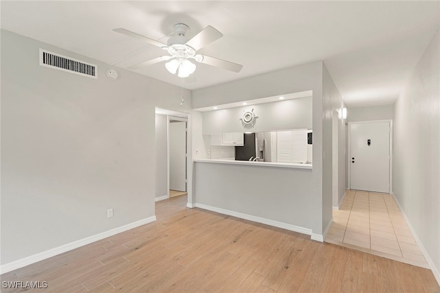 interior space featuring light hardwood / wood-style flooring and ceiling fan