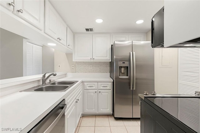 14 Manor Ter Unit 9-106, Marco Island, FL 34145 - kitchen featuring stainless steel appliances, light tile patterned floors, white cabinets, light countertops, and backsplash
