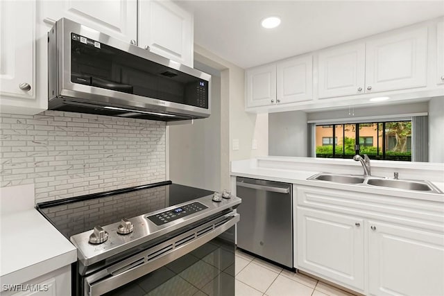 14 Manor Ter Unit 9-106, Marco Island, FL 34145 - kitchen featuring appliances with stainless steel finishes, light tile patterned floors, backsplash, white cabinetry, and recessed lighting