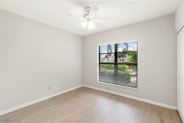 spare room with ceiling fan and light wood-type flooring