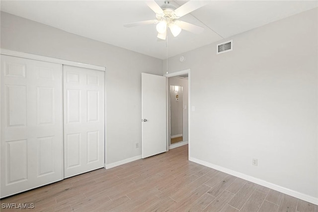 14 Manor Ter Unit 9-106, Marco Island, FL 34145 - unfurnished bedroom featuring light wood finished floors, a closet, and a ceiling fan