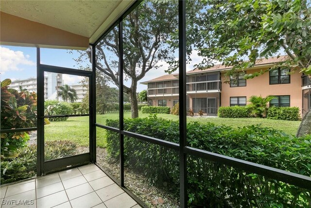14 Manor Ter Unit 9-106, Marco Island, FL 34145 - unfurnished sunroom featuring vaulted ceiling
