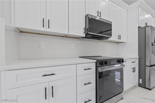 kitchen with appliances with stainless steel finishes and white cabinetry