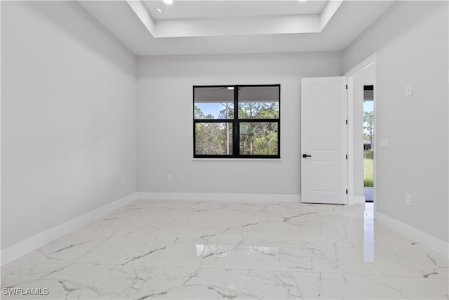 unfurnished room with a raised ceiling