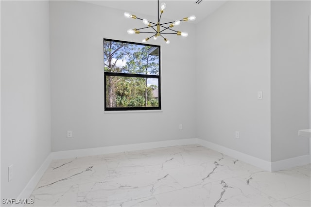 empty room featuring lofted ceiling and a chandelier