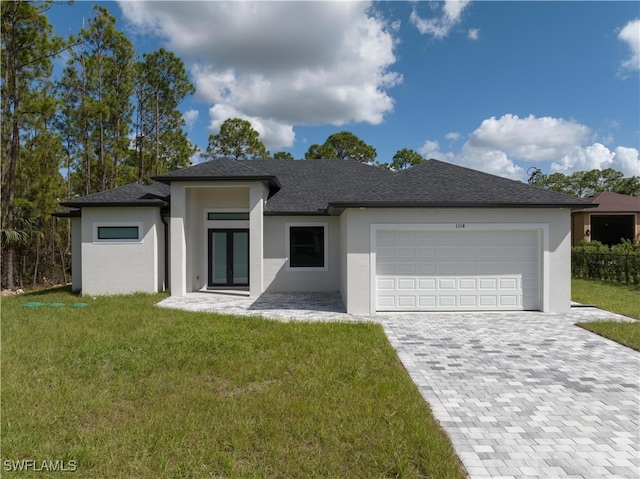 view of front of property with a front lawn and a garage