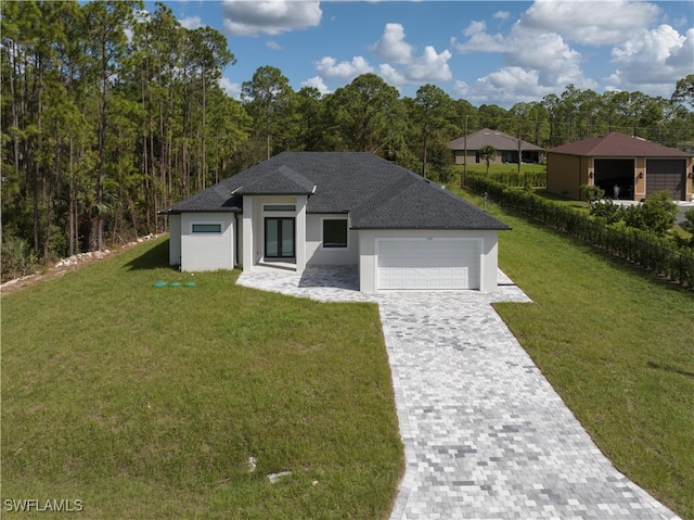 view of front of house with a front lawn and a garage