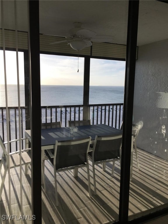 interior space featuring a water view and ceiling fan