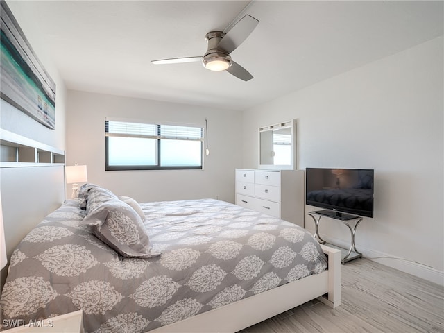 bedroom with light wood-type flooring and ceiling fan