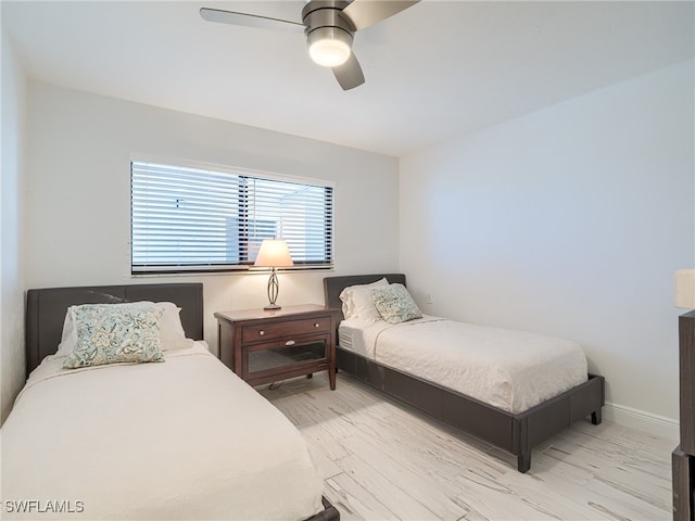 bedroom with ceiling fan and light hardwood / wood-style flooring