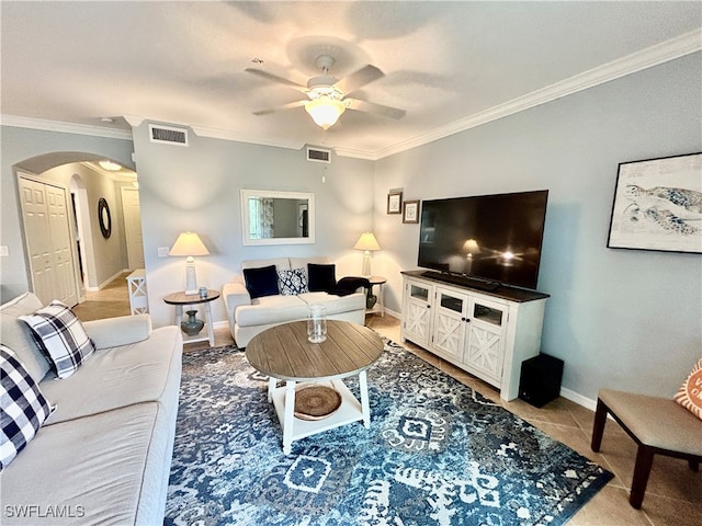 tiled living room featuring ceiling fan and ornamental molding