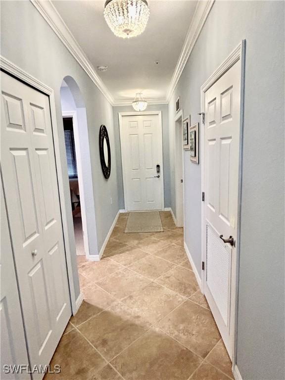 9834 Giaveno Cir Unit 1723, Naples, FL 34113 - hall with visible vents, ornamental molding, light tile patterned floors, arched walkways, and baseboards