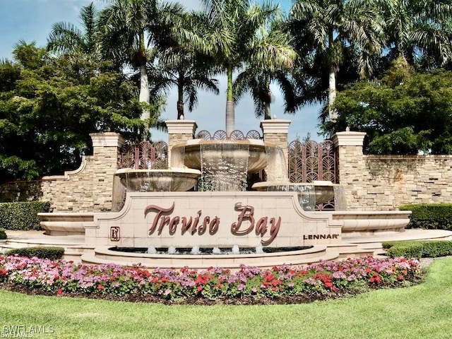 community / neighborhood sign featuring a lawn