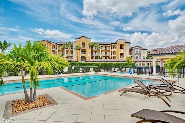 9834 Giaveno Cir Unit 1723, Naples, FL 34113 - community pool with fence and a patio area