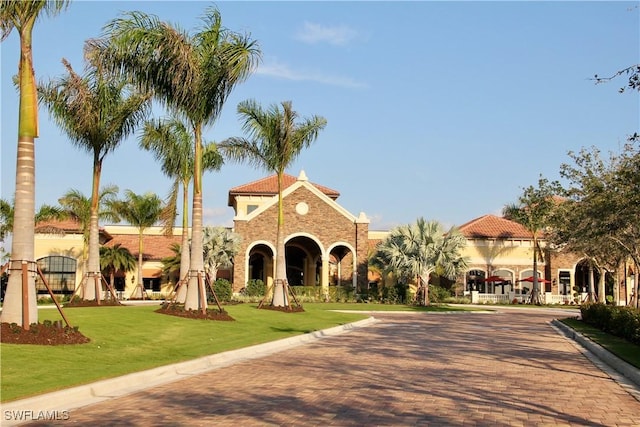 9834 Giaveno Cir Unit 1723, Naples, FL 34113 - view of front of property with a tile roof and a front yard