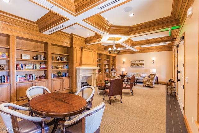 dining area with beam ceiling, ornamental molding, coffered ceiling, and built in features