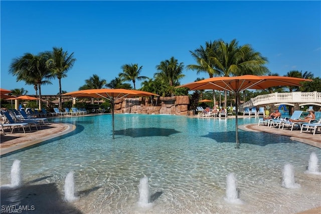 view of swimming pool with pool water feature