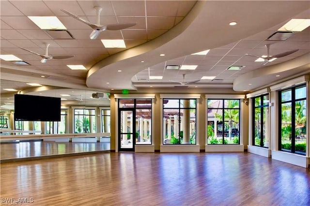 9834 Giaveno Cir Unit 1723, Naples, FL 34113 - workout room with a paneled ceiling, a ceiling fan, and wood finished floors