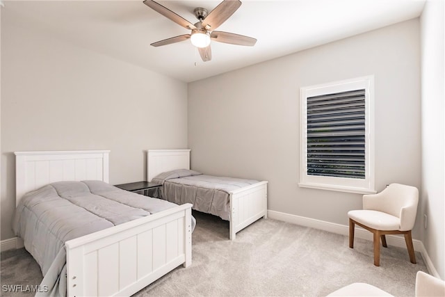 bedroom with light carpet and ceiling fan