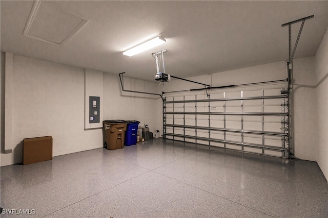 garage with a garage door opener and electric panel