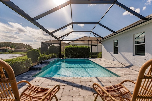 view of swimming pool with a patio, pool water feature, and glass enclosure