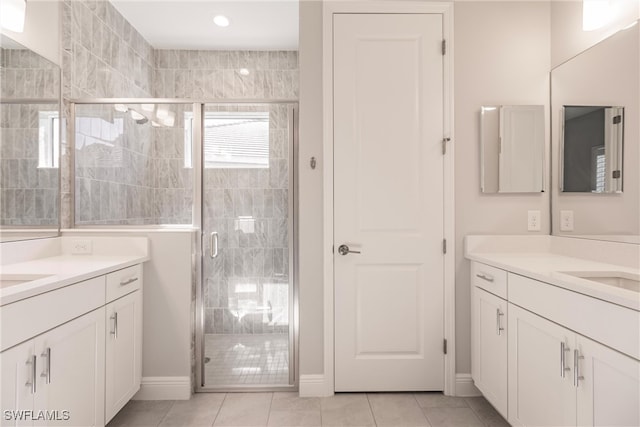 bathroom featuring vanity, tile patterned flooring, and an enclosed shower