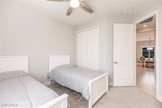 carpeted bedroom with a closet and ceiling fan