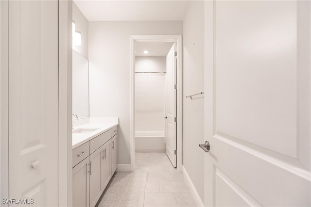 bathroom featuring vanity, tile patterned floors, and  shower combination