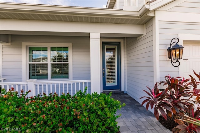 property entrance featuring covered porch