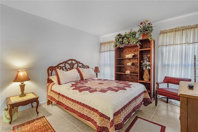 bedroom featuring light tile patterned flooring and multiple windows